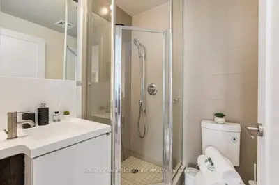 a bathroom with a shower and a toilet and a sink at Belarte Suites - Downtown Toronto - CN Tower & Rogers Centre in Toronto