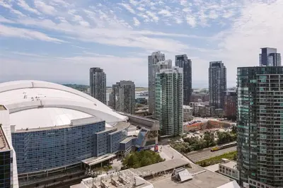 a view of a city with a large building at Belarte Suites - Downtown Toronto - CN Tower & Rogers Centre in Toronto
