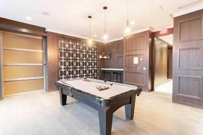 a pool table in a room with wine racks at Belarte Suites - Downtown Toronto - CN Tower & Rogers Centre in Toronto