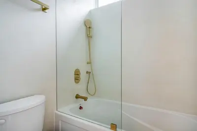 a bathroom with a shower with a glass door at White Rose Chalet at Blue Mountains for 20 w Hot Tub in Blue Mountains