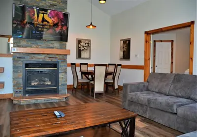 a living room with a couch and a fireplace at The Blue Mountains Chalet for 20- 8BR Bliss w Hot Tub in Blue Mountains