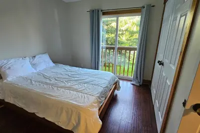 a bedroom with a bed and a large window at All-Season 8BR Vacation Chalet in Blue Mountains