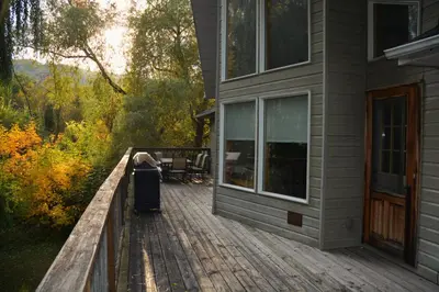 a house with a deck with a trash can on it at All-Season 8BR Vacation Chalet in Blue Mountains