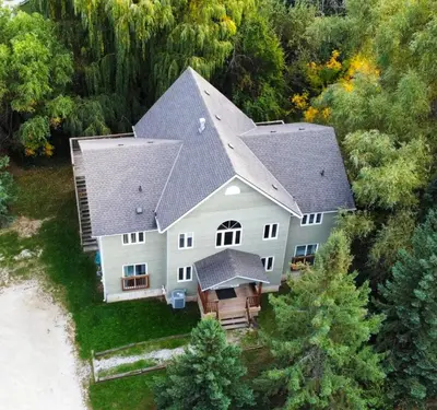 an aerial view of a large house with a roof at All-Season 8BR Vacation Chalet in Blue Mountains