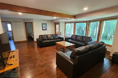 a living room with leather couches and a table at All-Season 8BR Vacation Chalet in Blue Mountains