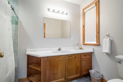 a bathroom with a sink and a mirror at The Four Leaf Clover at The Blue Mountains for 12 in Blue Mountains