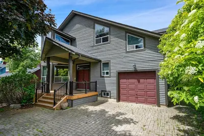 a gray house with a red garage at The Four Leaf Clover at The Blue Mountains for 12 in Blue Mountains
