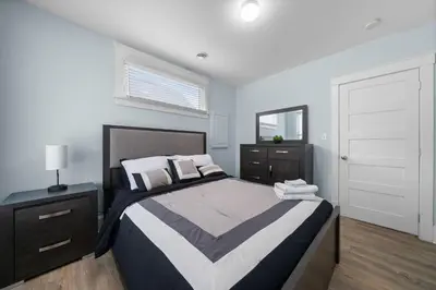 a bedroom with a large bed and a window at The Harlequin - 20 Summer Village in Cherry Valley