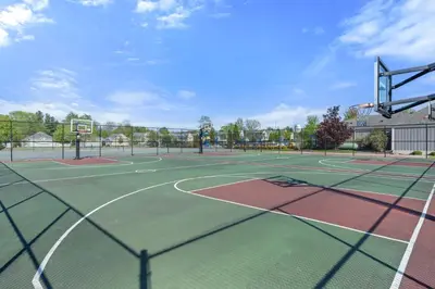 a tennis court with two tennis courts at The Cattail - 26 Meadowview in Cherry Valley