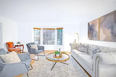 a living room with a couch and a table at Luxury Old Town Winter Retreat- Hot Tub and Games in Niagara on the Lake