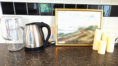 a kitchen counter with a coffee pot and a picture at Luxury Old Town Winter Retreat- Hot Tub and Games in Niagara on the Lake