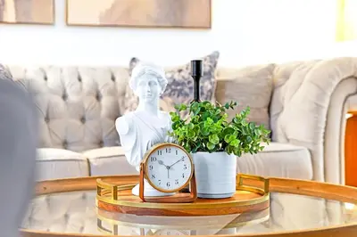 a table with a clock and a statue on it at Luxury Old Town Winter Retreat- Hot Tub and Games in Niagara on the Lake