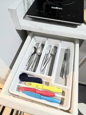 a drawer in a table filled with utensils at Welcome to your Serene Gateway in London