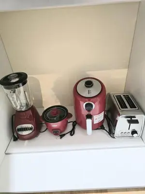 a shelf with a blender and other appliances on it at Welcome to your Serene Gateway in London