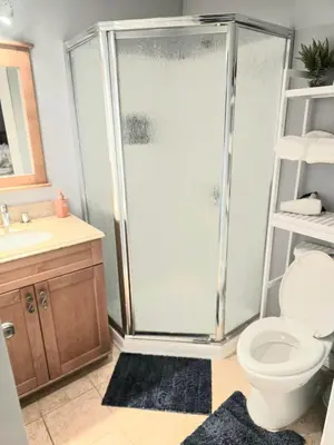 a bathroom with a shower with a toilet and a sink at Welcome to your Serene Gateway in London