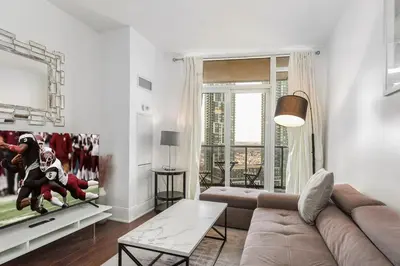a living room with a couch and a table at Luxurious 2BR 2BATH Condo Steps from Square One in Mississauga