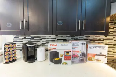 a kitchen counter with a box and appliances on it at An Ideal Home Away From Home in London