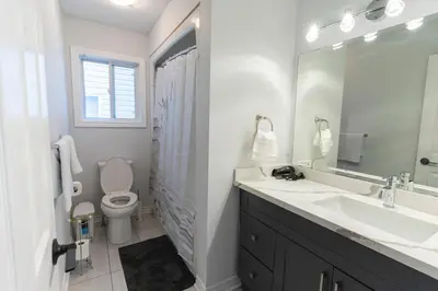 a bathroom with a sink and a toilet and a mirror at An Ideal Home Away From Home in London
