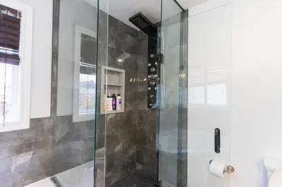 a shower with a glass door in a bathroom at An Ideal Home Away From Home in London