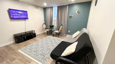 a living room with a couch and a table at Cozy 2Bed Home 6 minutes to the FALLS! in Niagara Falls
