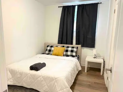 a small bedroom with a bed and a window at Cozy 2Bed Home 6 minutes to the FALLS! in Niagara Falls