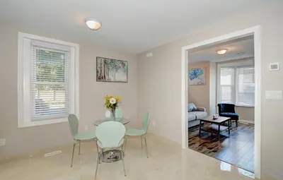 a dining room with a table and chairs at Spacious Modern Condo In Kitchener in Kitchener