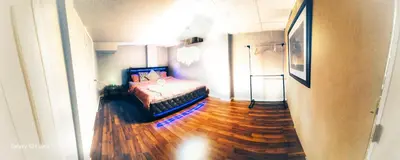 a bedroom with a bed and a wooden floor at 70 percent Off Luxurious Hot Tub,Sauna, 2000Sqft of Private in Vaughan