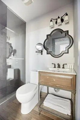 a bathroom with a toilet and a sink and a mirror at La TUMU in Toronto