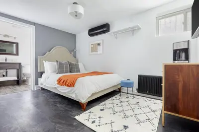 a bedroom with a bed and a desk and a piano at La TUMU in Toronto