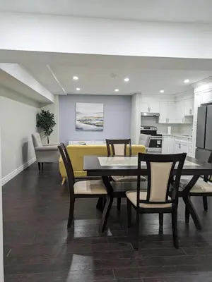 a kitchen and dining room with a table and chairs at Kings Palace Basement in Brampton