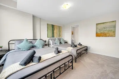 a bedroom with three beds in a room at Spacious 6bed Home near Pier Niagara Toronto QEW in Burlington