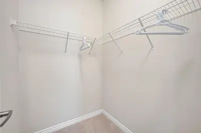 a room with a white wall with a rack on the wall at Spacious 6bed Home near Pier Niagara Toronto QEW in Burlington