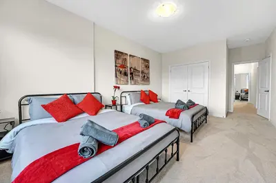 a bedroom with two beds with red pillows at Spacious 6bed Home near Pier Niagara Toronto QEW in Burlington