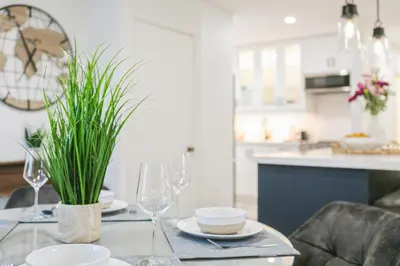a dining table with glasses and a plant on it at Stylish 3br Home, Close To Restaurantsshops in Mississauga
