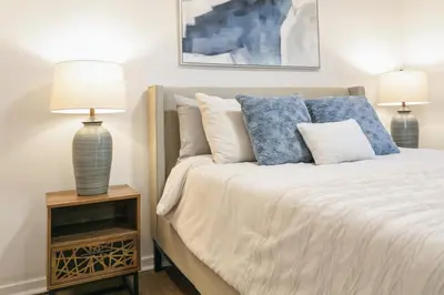 a bedroom with a bed with two lamps on a night stand at Stylish 3br Home, Close To Restaurantsshops in Mississauga
