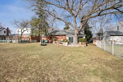 a large yard with a house and a fence at Stylish 3br Home, Close To Restaurantsshops in Mississauga