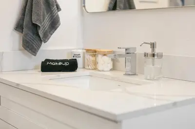 a white bathroom counter with a sink and a mirror at Stylish 3br Home, Close To Restaurantsshops in Mississauga