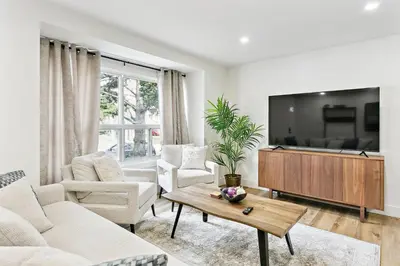 a living room with a couch and a tv at Stylish 3br Home, Close To Restaurantsshops in Mississauga