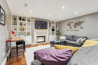 a living room with a couch and a fireplace at Cozy & Stylish 2br W Hot Tub & Fireplaces in Mississauga