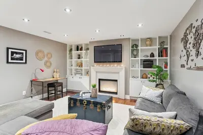 a living room with a couch and a fireplace at Cozy & Stylish 2br W Hot Tub & Fireplaces in Mississauga