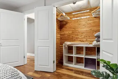 a room with a closet with a wooden wall at Cozy & Stylish 2br W Hot Tub & Fireplaces in Mississauga