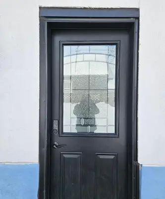 a black door with a window on a building at Queen bedroom in Toronto
