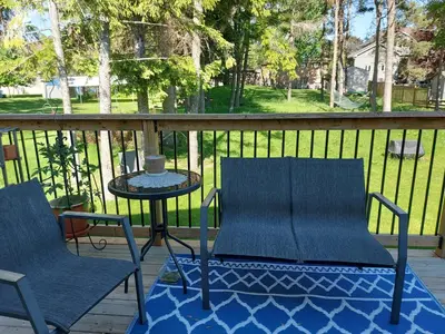 two chairs and a table on a porch at Soloquester's BnB in Zurich