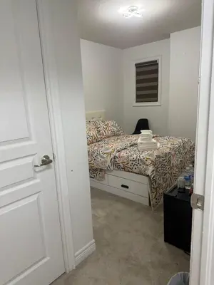 a bedroom with a bed and a door to a room at Dream Homes in Thorold