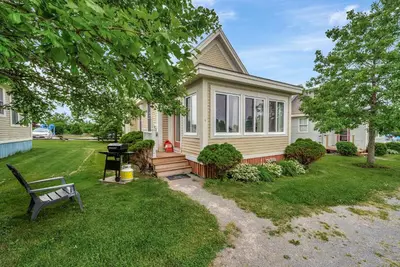 a house with a bench in front of it at The Chicory - 4 Meadow View in Cherry Valley