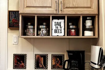 a kitchen cabinet with spices and signs on it at The Artists' House Getaway in Collingwood