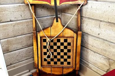 a checkered board hanging on a wall at The Artists' House Getaway in Collingwood