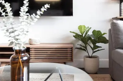 a living room with a table and a vase of flowers at Downtown 1BR Modern Condo in Toronto