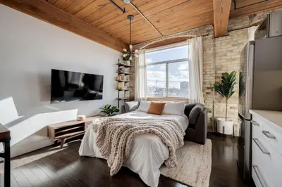 a bedroom with a bed and a large window at Downtown 1BR Modern Condo in Toronto