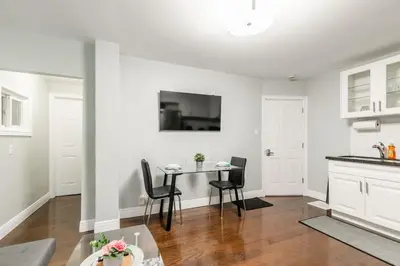 a kitchen and dining room with a table and chairs at Chic 3BR apartment in Queen West, Downtown Toronto in Toronto